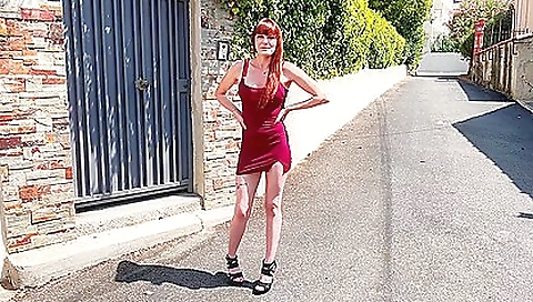 Redheaded woman in a dental practice in a sexy dress