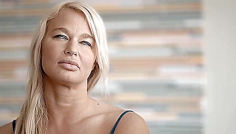 Blonde milf with huge breasts gives a blowjob to her lover