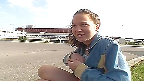 Sexy brunette amateur solo female in a dress outdoors